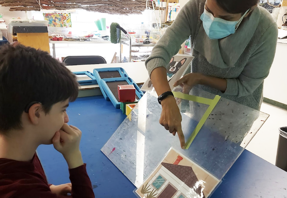 facilitator is modeling an activity for a student